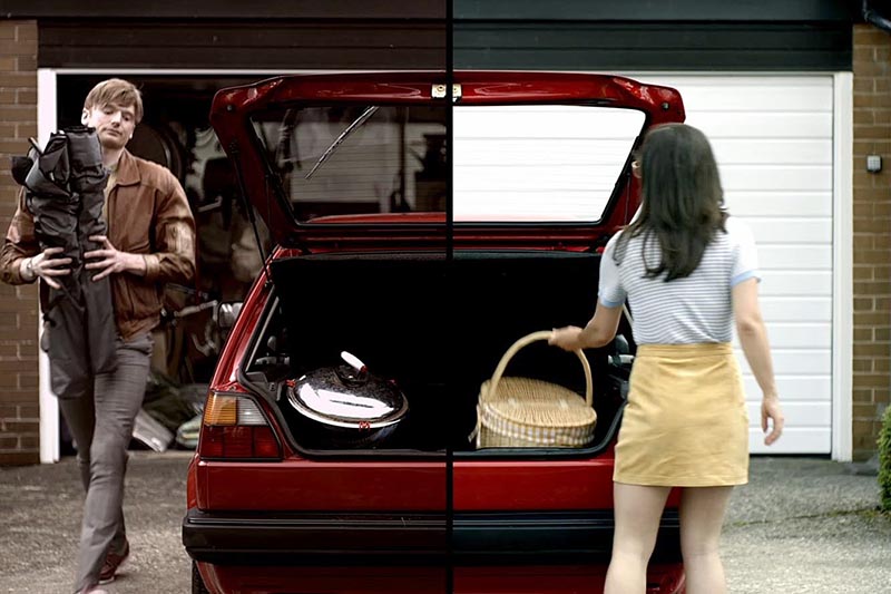Image of a Girl and a boy going on a trip and packing their stuff in the car, boy is bringing tent and girl keeping basket in the boot.